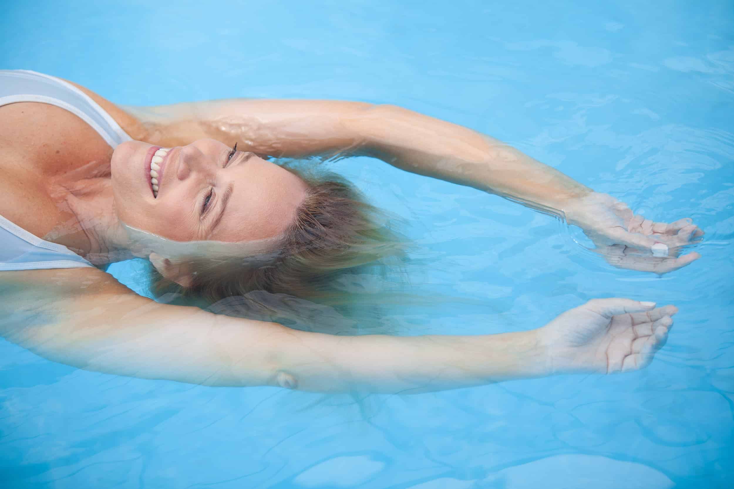 middle aged woman relaxing in pool