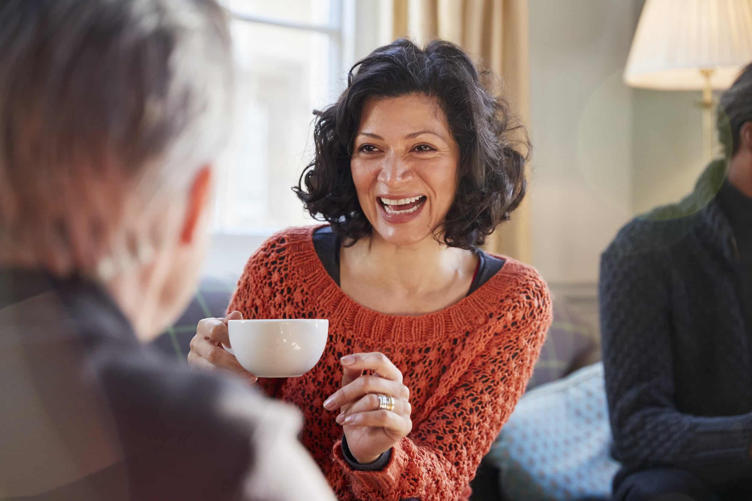 middle aged woman having coffee with friends