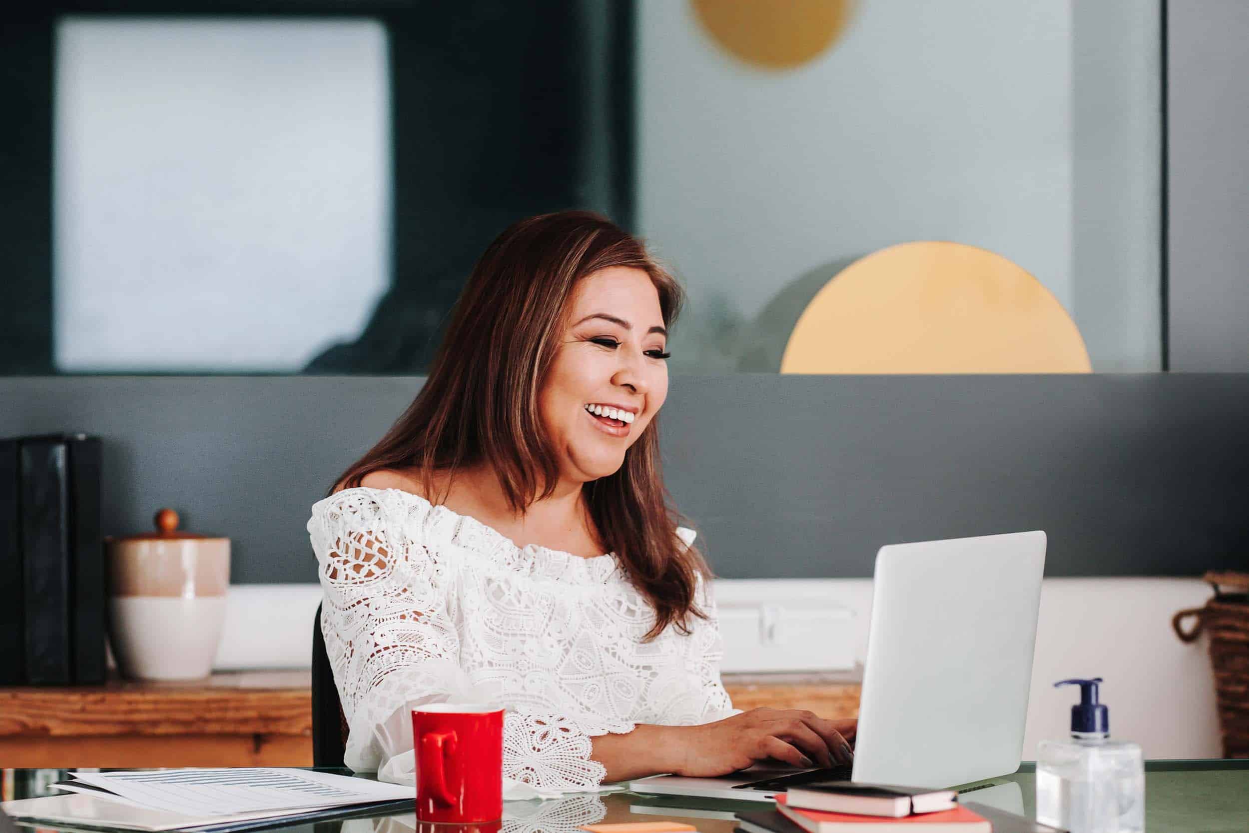 joyful woman looking on her laptop