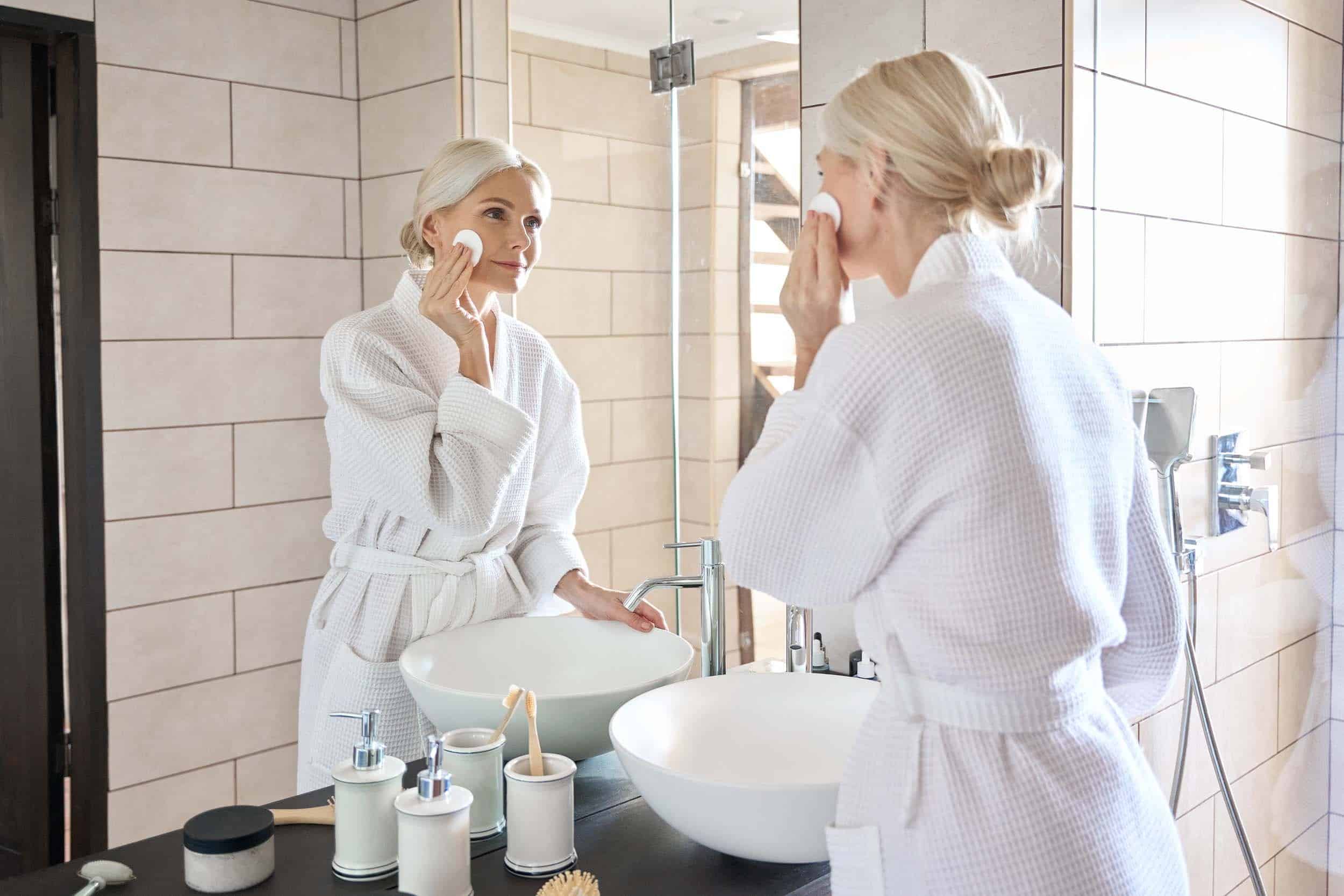 middle aged woman doing facial care for her skin health