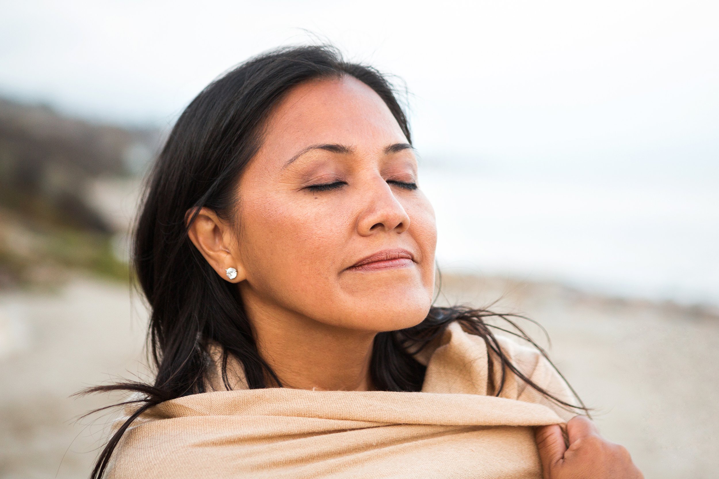 woman on the beach breathing fresh air