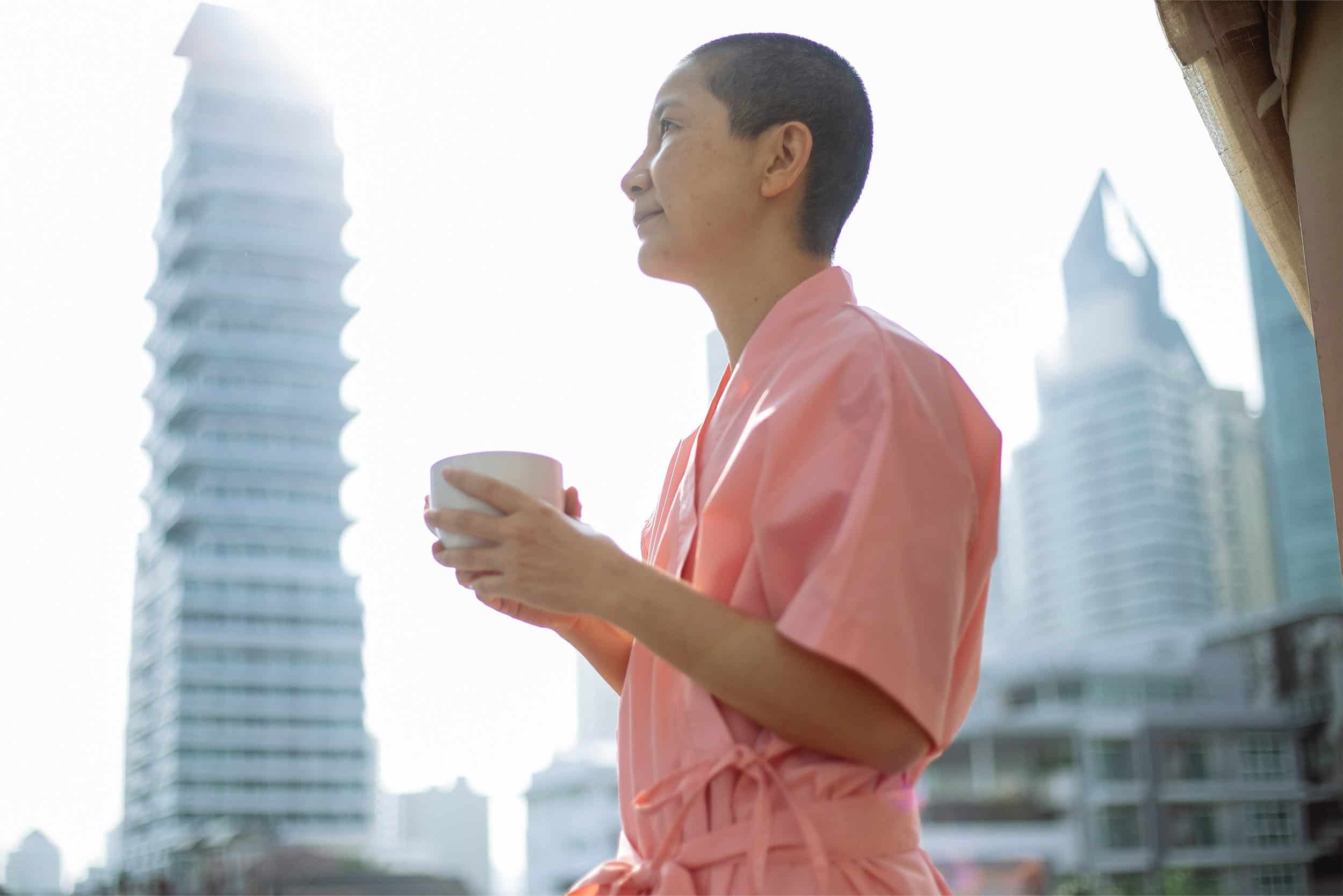 asian woman having a morning cup of tea
