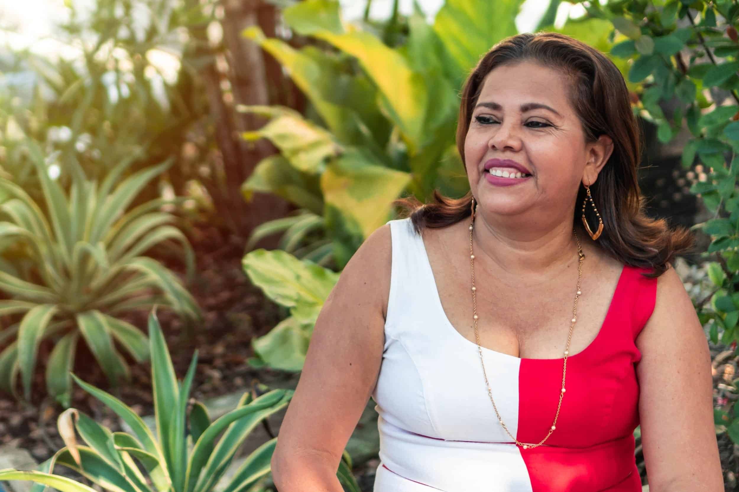 woman in her 40s smiling while looking at her side