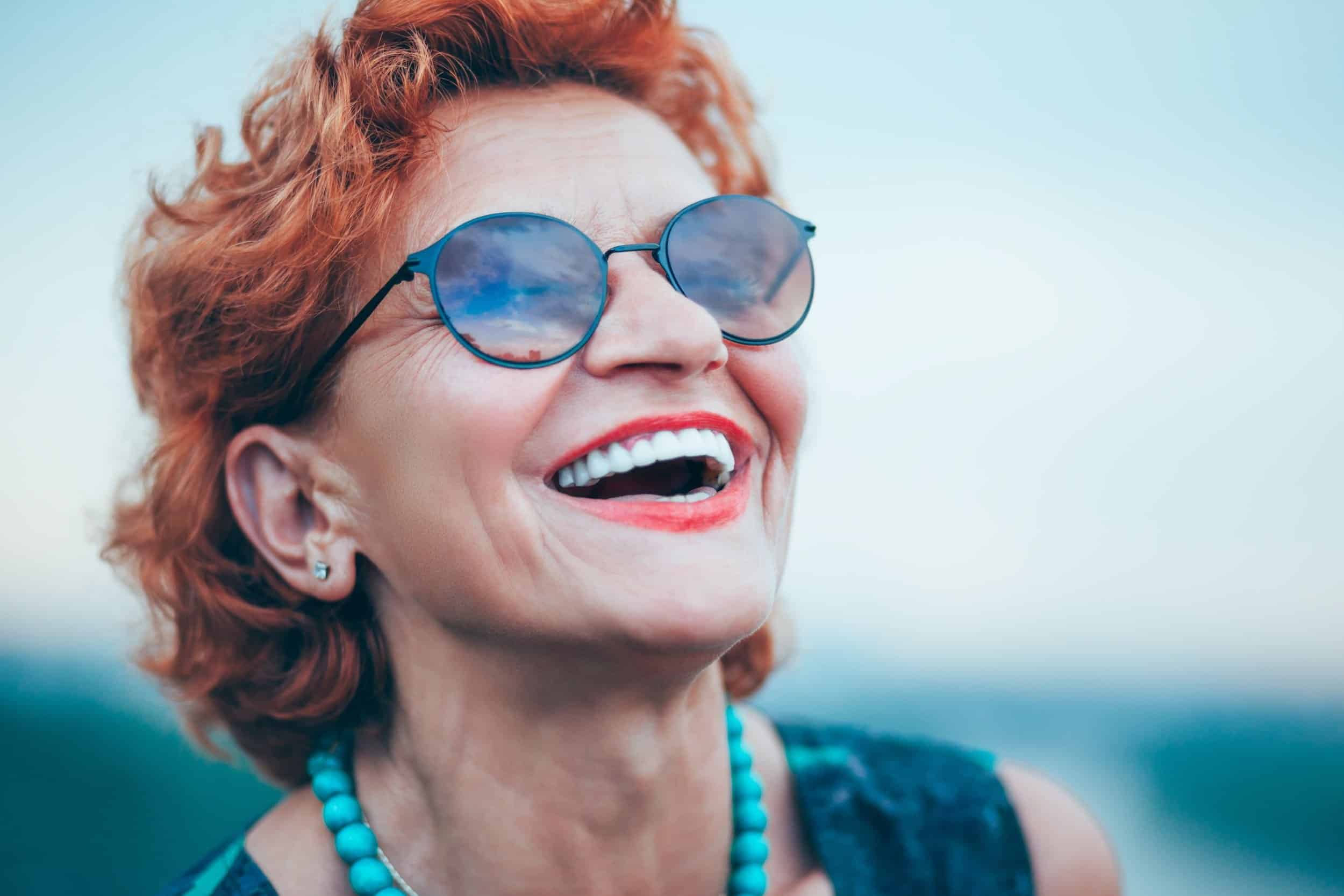 woman in her 50s smiling beautifully while looking at the sky