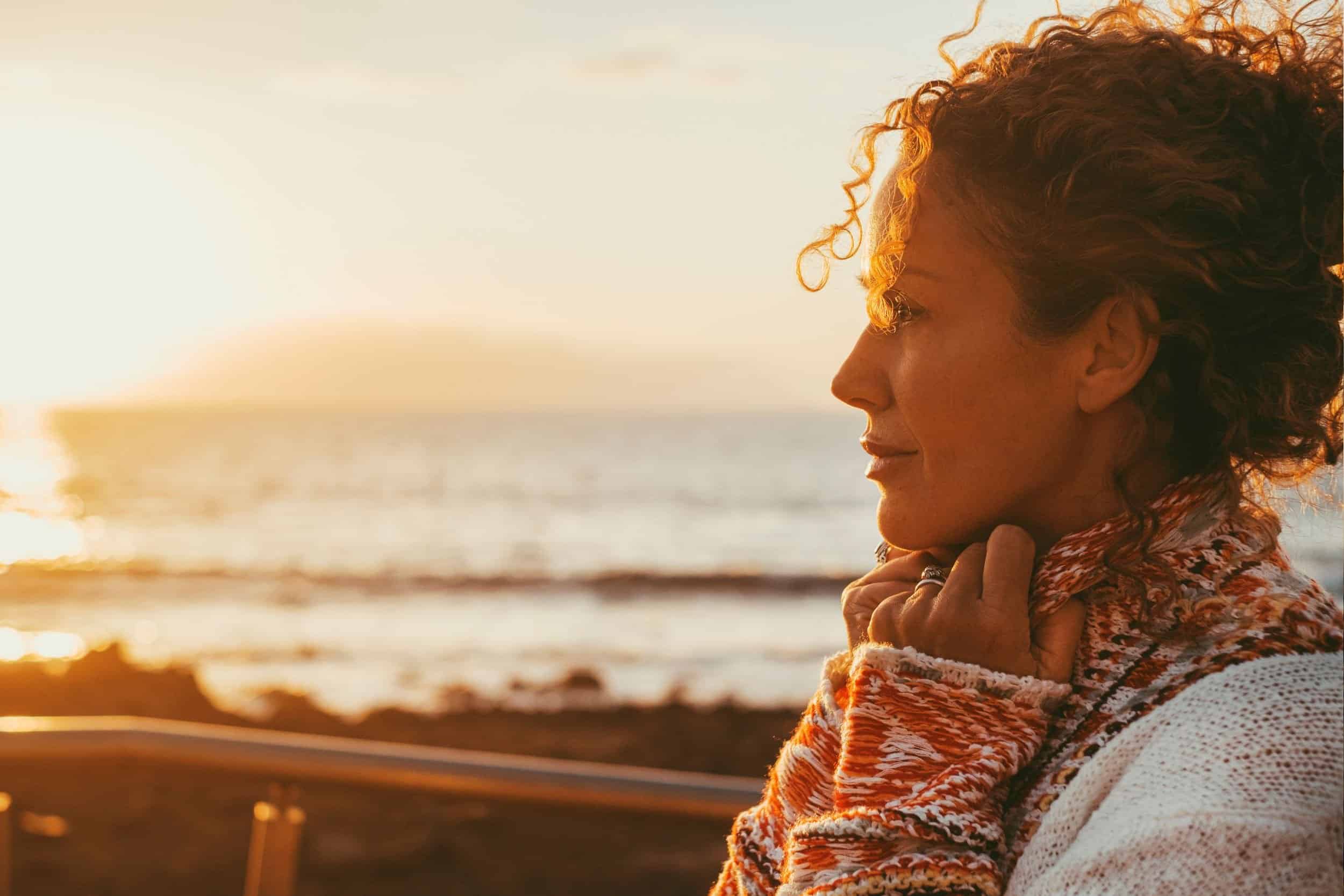 woman in her 40s wondering while looking at the sea