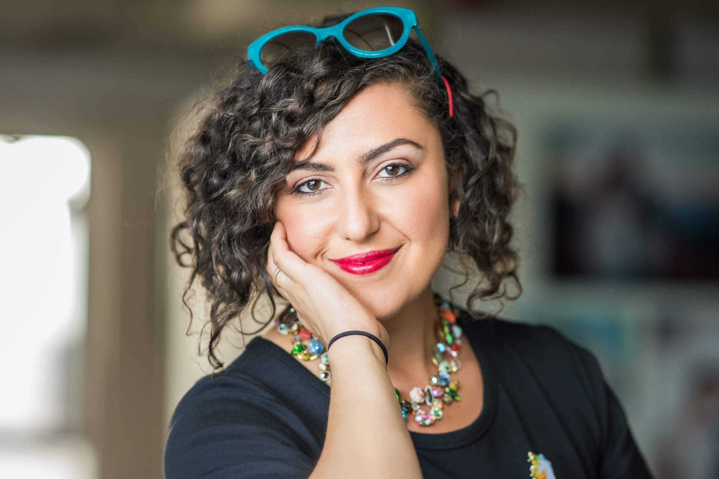 confident woman in her 40s wearing a colorful necklace